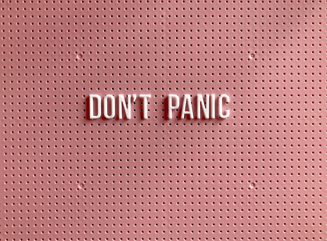 don't panic text on pink and white polka dot background